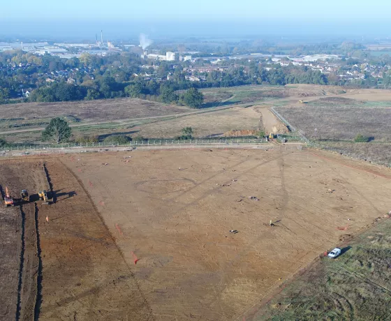 Aerial view of the Gilden Way site with features in the foreground and Harlow in the background